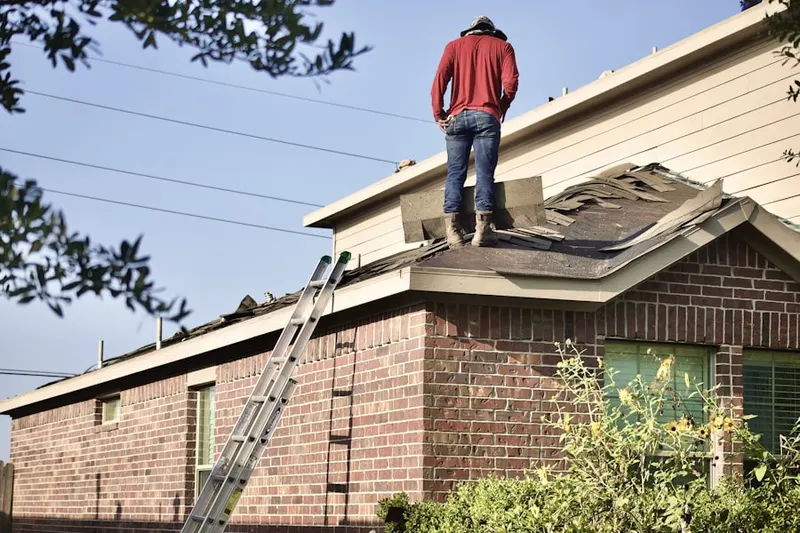 Professional roofer working on a residential roof in Carroll Meadows